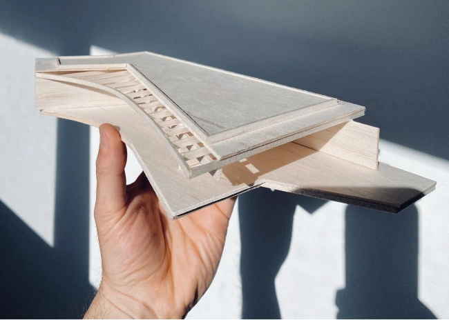 Hand holding a architectural model of Dusty Miller house