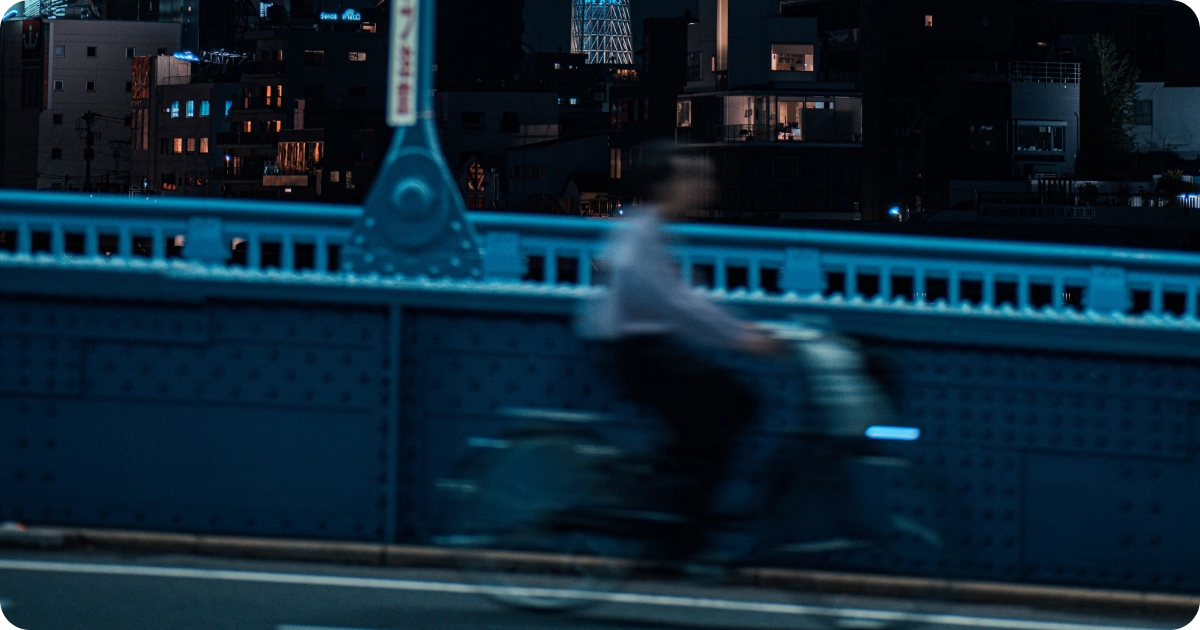 man cyling through tokyo